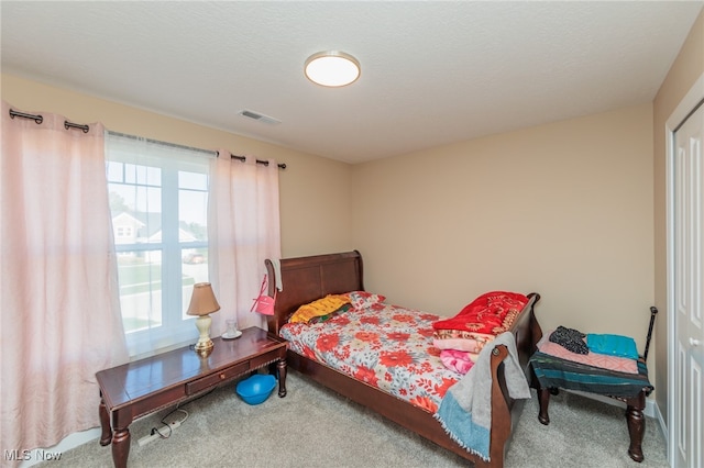 carpeted bedroom with a textured ceiling