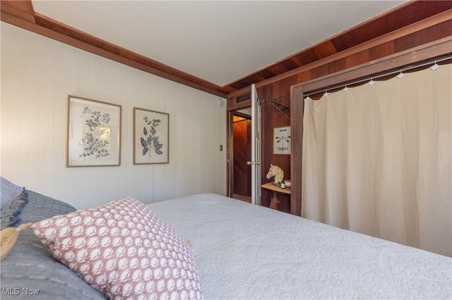 bedroom with wood walls