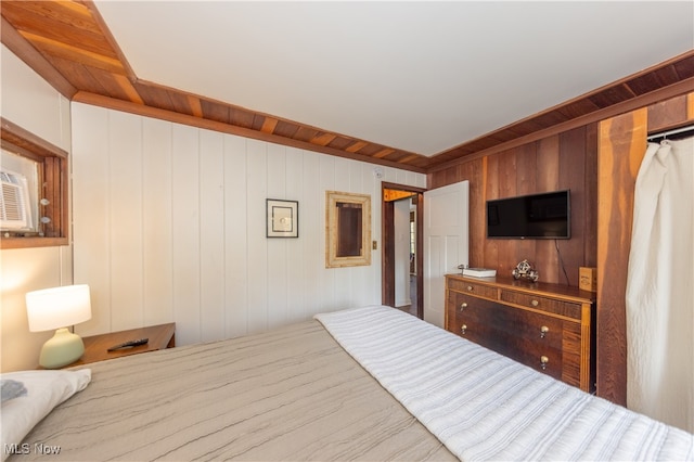 bedroom featuring wooden walls