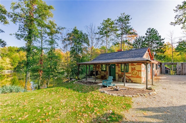 exterior space featuring a yard and a water view