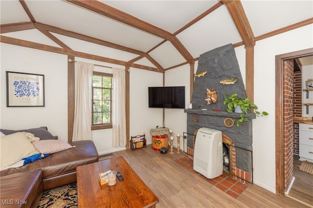 living room with vaulted ceiling with beams and light hardwood / wood-style floors