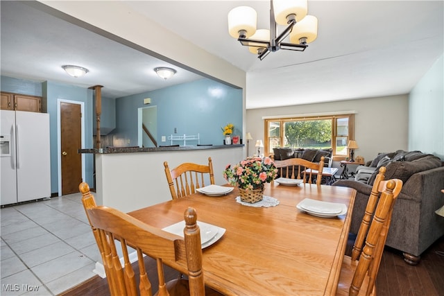 dining area featuring a chandelier and light wood-type flooring