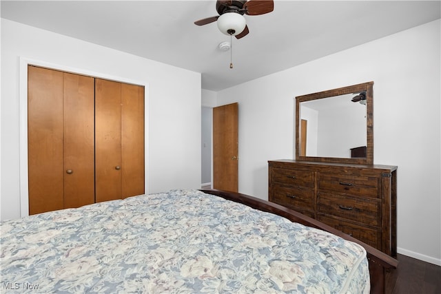 bedroom featuring dark hardwood / wood-style flooring, a closet, and ceiling fan