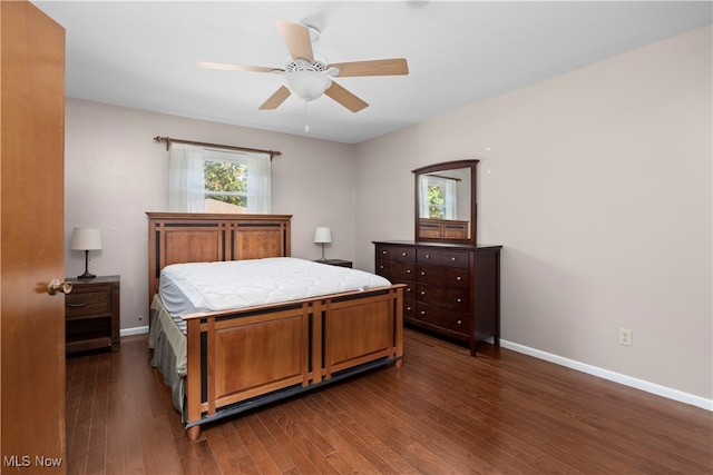 bedroom with dark hardwood / wood-style flooring and ceiling fan