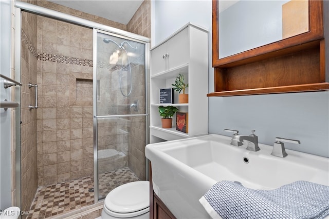 bathroom with toilet, walk in shower, and vanity