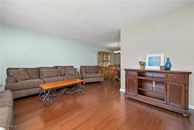 living room featuring dark wood-type flooring and a chandelier