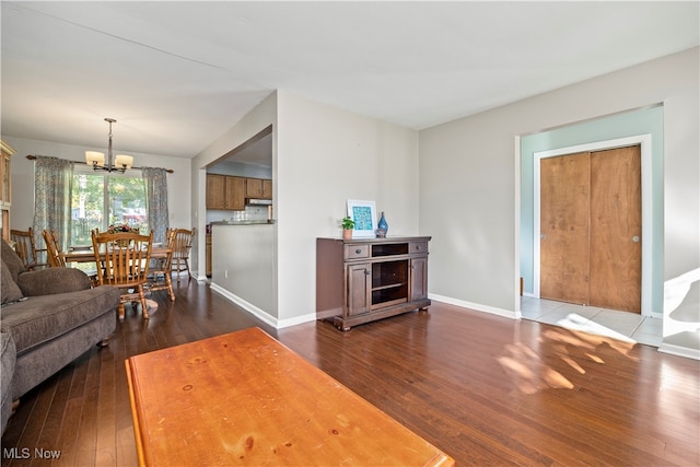 living room featuring dark hardwood / wood-style flooring and a chandelier