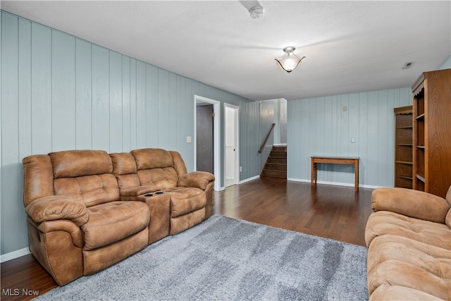 living room with wooden walls and dark hardwood / wood-style floors