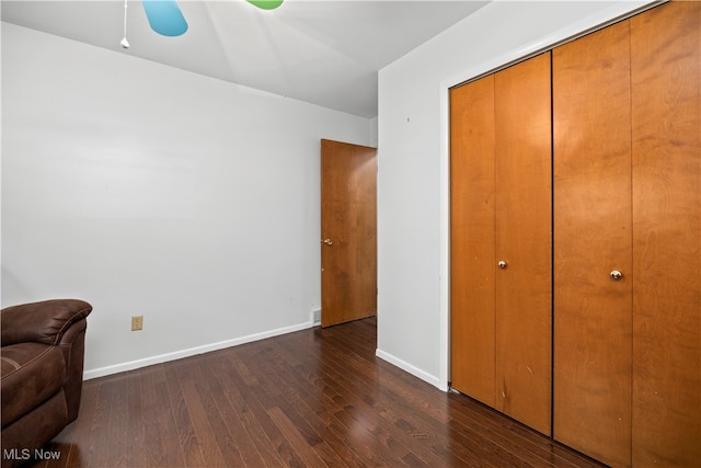 bedroom with a closet, ceiling fan, and dark hardwood / wood-style flooring