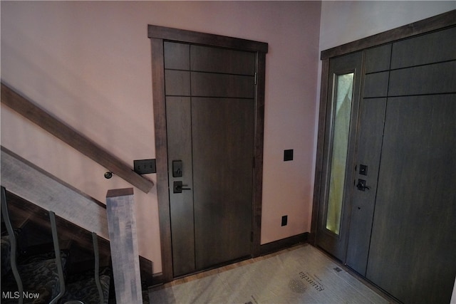 entrance foyer featuring lofted ceiling with beams