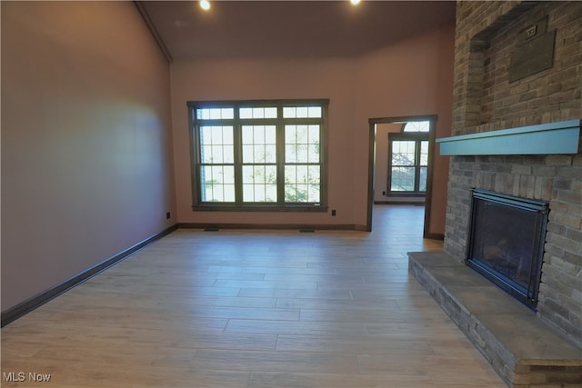 unfurnished living room featuring a fireplace and light wood-type flooring