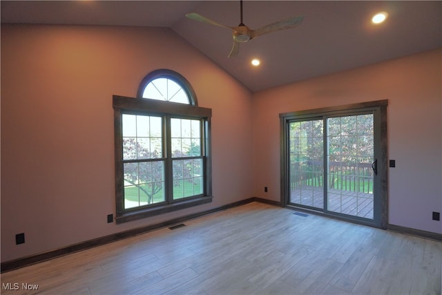 empty room featuring lofted ceiling, light wood-type flooring, and ceiling fan