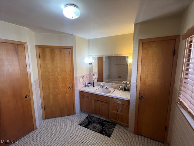 bathroom with vanity, tile patterned floors, and tile walls