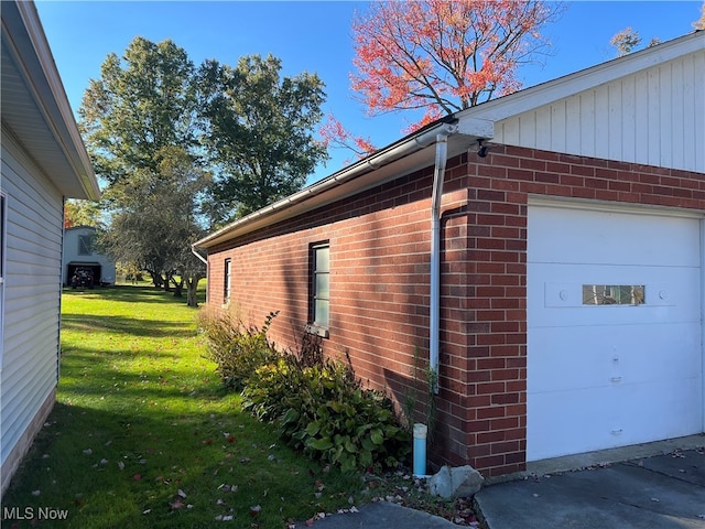 view of home's exterior with a yard and a garage