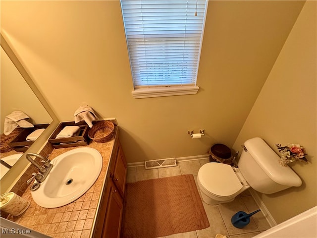 bathroom with vanity, toilet, and tile patterned flooring