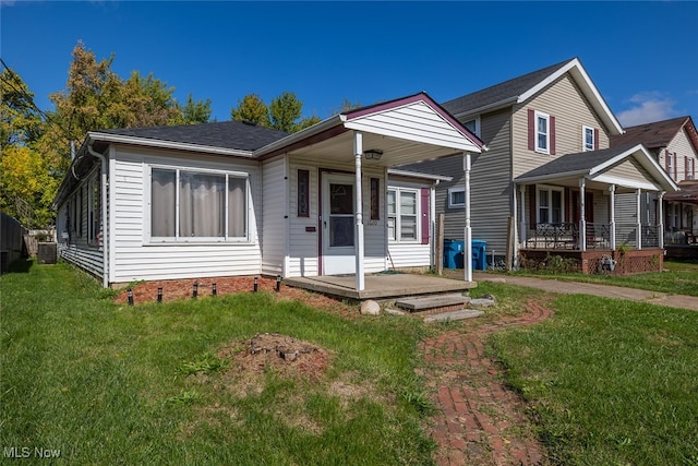 view of front of home featuring a front yard and a porch