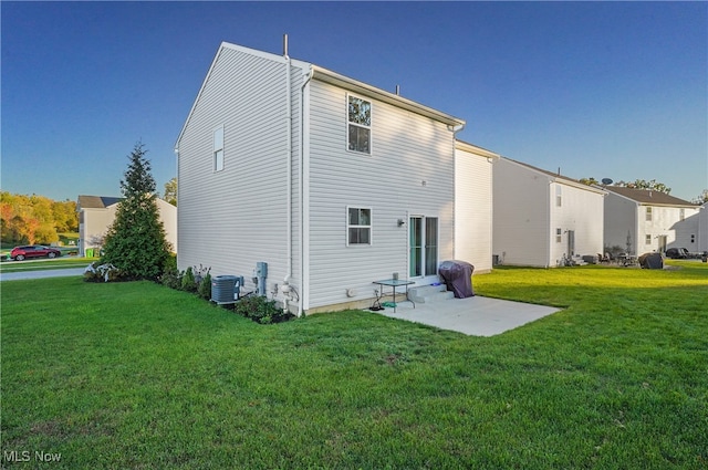 rear view of house with a patio, a lawn, and central AC unit