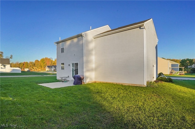 rear view of property featuring a yard and a patio