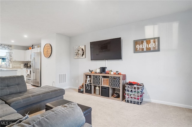 living room featuring light carpet