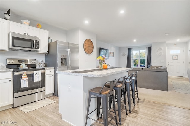 kitchen featuring a center island, appliances with stainless steel finishes, and white cabinetry