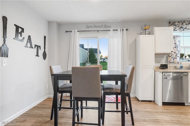 dining space with light hardwood / wood-style flooring