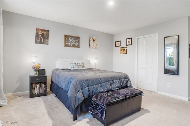 bedroom with a closet and light colored carpet