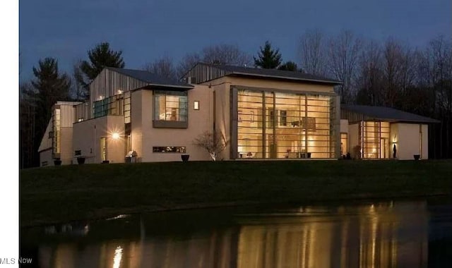 view of front of home with a yard and stucco siding