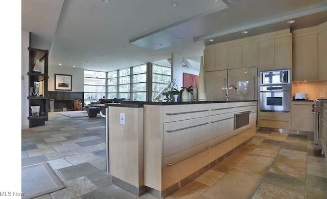 kitchen with decorative backsplash and stainless steel microwave