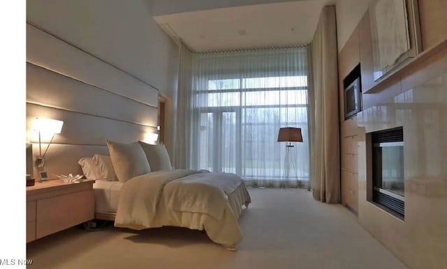 bedroom featuring light colored carpet