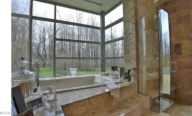 bathroom with a healthy amount of sunlight, tile patterned floors, and separate shower and tub