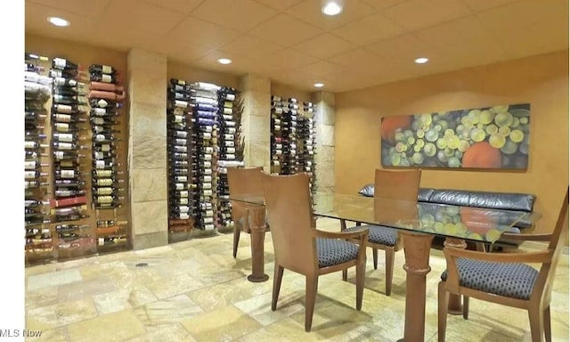 wine area featuring a paneled ceiling and recessed lighting