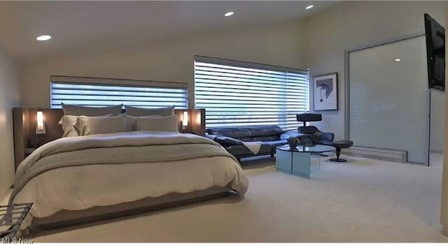 bedroom with multiple windows, carpet floors, and vaulted ceiling