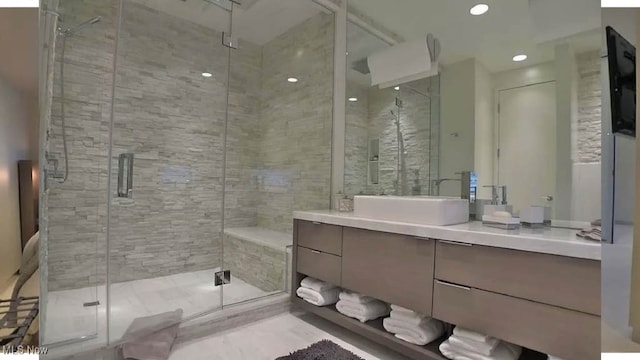 bathroom featuring recessed lighting, vanity, and a stall shower