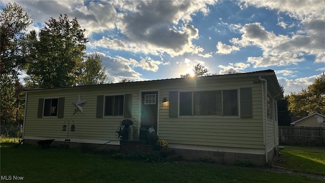 rear view of house with a lawn