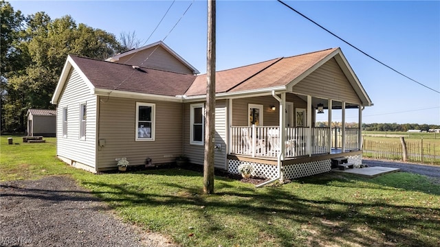 view of front of house featuring covered porch and a front lawn