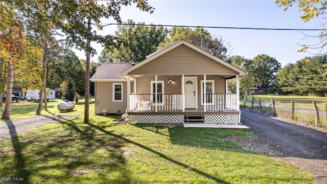 bungalow-style home featuring a front yard and a porch