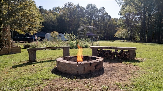 view of yard featuring an outdoor fire pit