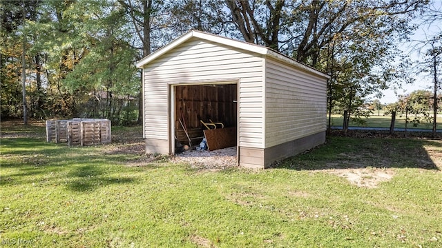 view of outdoor structure featuring a lawn