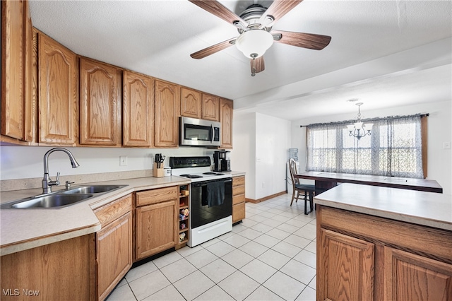 kitchen with light tile patterned flooring, sink, ceiling fan with notable chandelier, pendant lighting, and white range with electric stovetop