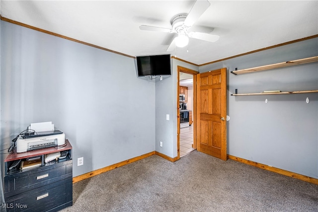 unfurnished bedroom with ceiling fan, crown molding, and carpet floors