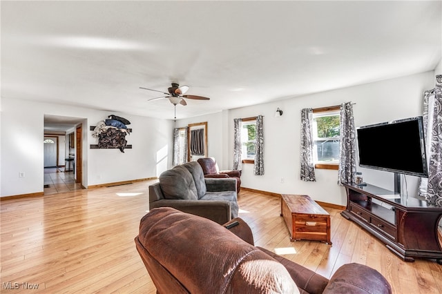 living room featuring light hardwood / wood-style flooring and ceiling fan