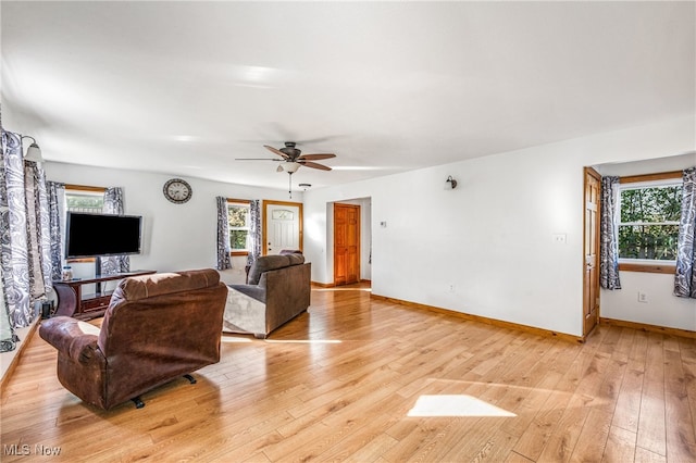 living room featuring light hardwood / wood-style flooring and ceiling fan