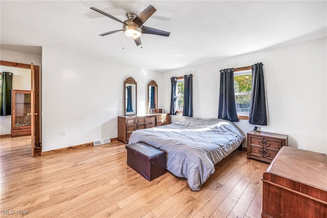 bedroom with light wood-type flooring and ceiling fan