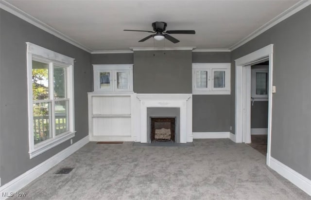 unfurnished living room with ceiling fan, ornamental molding, and light colored carpet