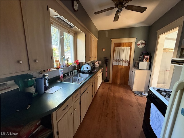 kitchen featuring sink, ceiling fan, light wood-type flooring, and gas range gas stove