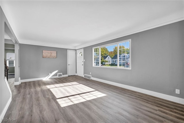 unfurnished room with crown molding and hardwood / wood-style floors