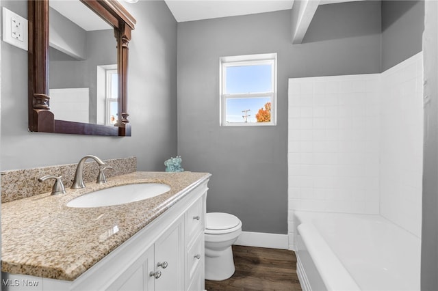 full bathroom featuring vanity, toilet, hardwood / wood-style flooring, and shower / tub combination