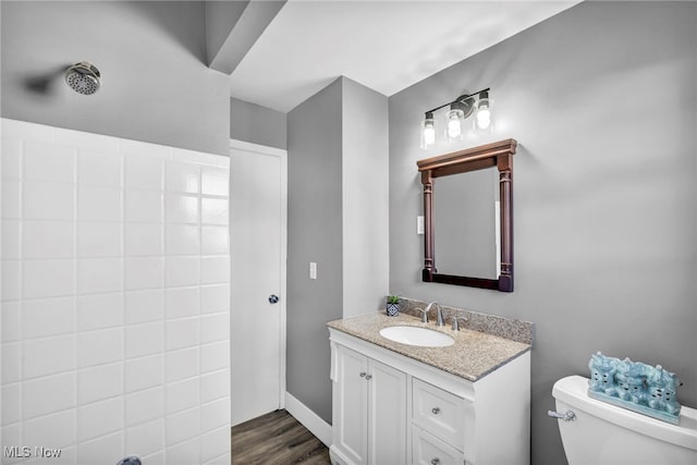 bathroom featuring vanity, toilet, and hardwood / wood-style flooring