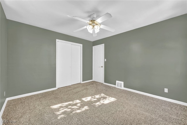 unfurnished bedroom featuring a closet, ceiling fan, and carpet