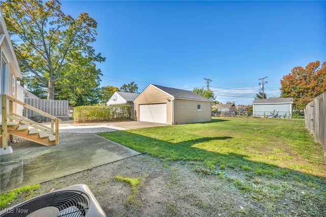 view of yard featuring central air condition unit, an outdoor structure, and a garage